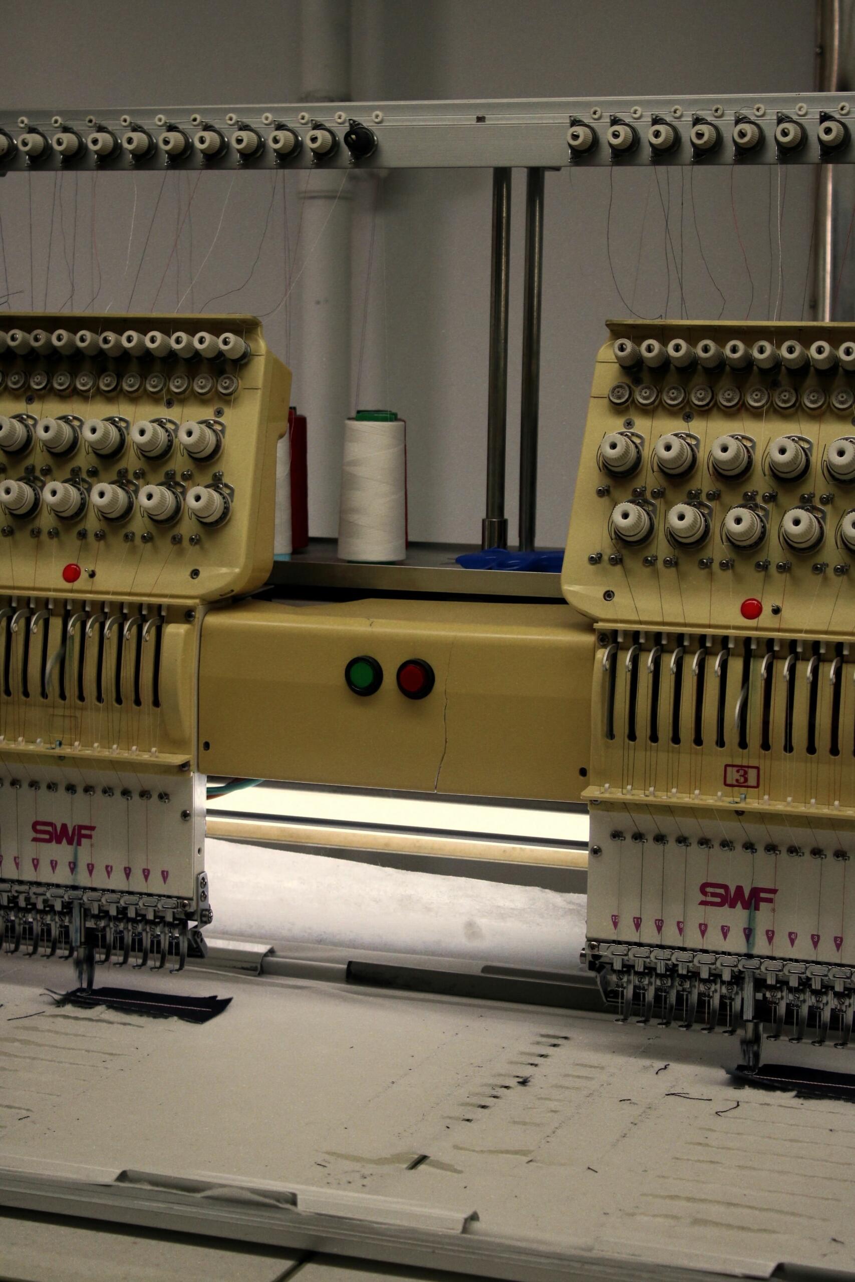 Embroidery machine working on fabric for premium garment branding