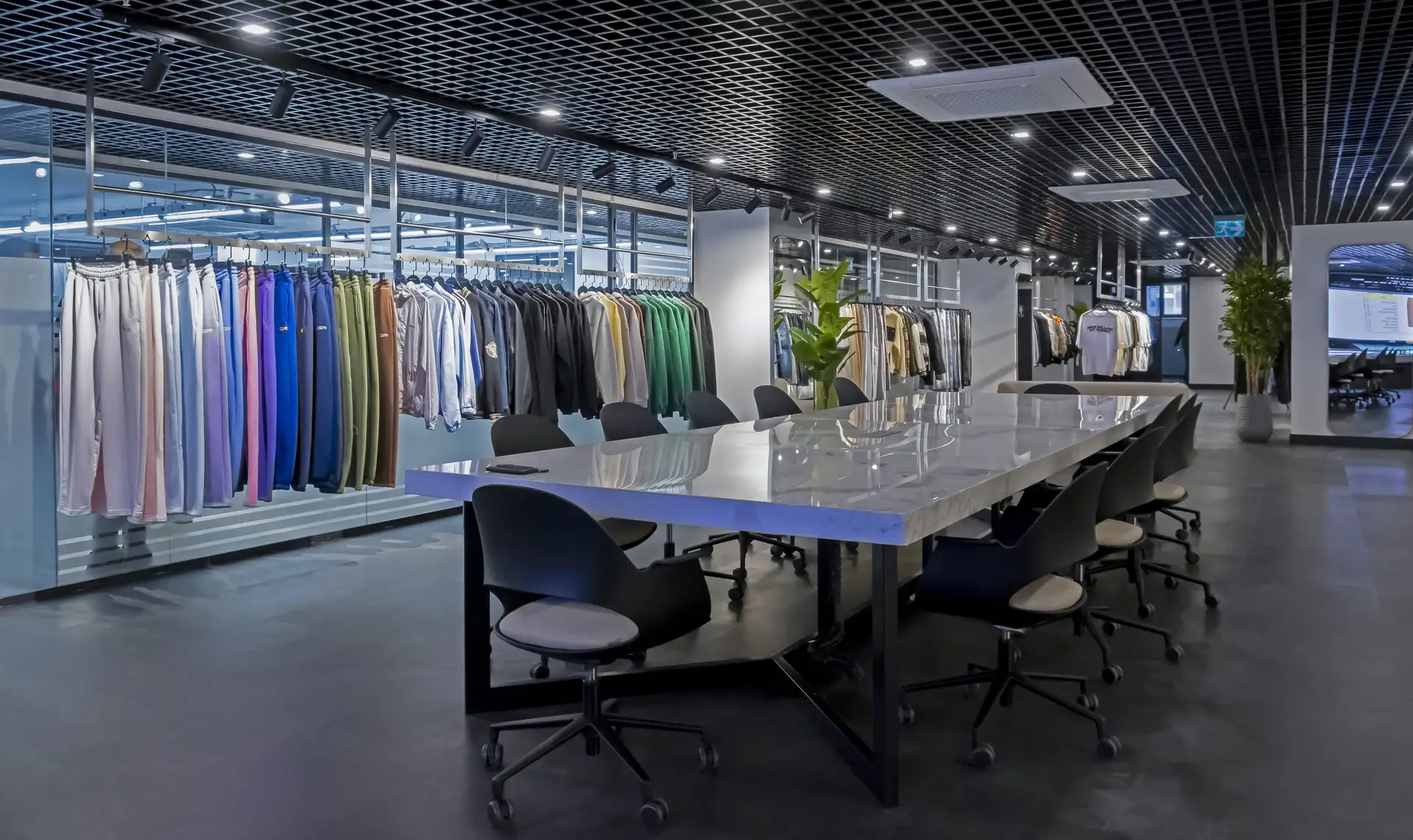 Focused capsule clothing collection with coordinated garments inside a modern apparel factory